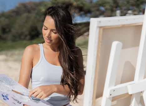 Isabella painting on the beach